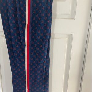 Gucci silk Ghost collaboration navy with red ghost icon detail pants.